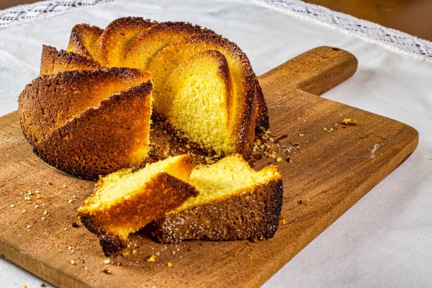 istock Cornmeal cake. Typical Brazilian cornmeal cake on a white porcelain plate with enameled colored agate coffee cups on the side 1226967873