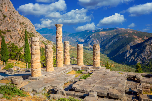 Famous Greek Ancient Ruins - The Temple of Apollo in Delphi, Greece in a summer day, European travel Famous Greek Ancient Ruins - The Temple of Apollo in Delphi, Greece in a summer day, European travel oracle building stock pictures, royalty-free photos & images