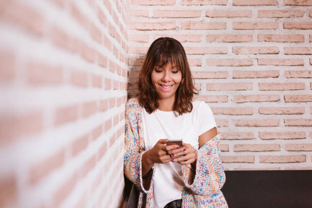 istock young caucasian woman using mobile outdoors. technology concept 1226969634