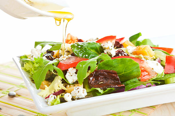 Fresh goat cheese salad.  arugula falling stock pictures, royalty-free photos & images
