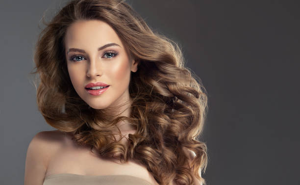 istock Pretty looking model is smiling tenderly and looking kindly at viewers 1226971110