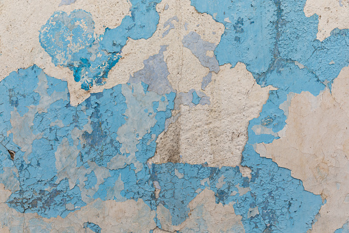 Painted distressed wall surface. Urban background grunge wall texture - old bricks and paint cracked wall texture