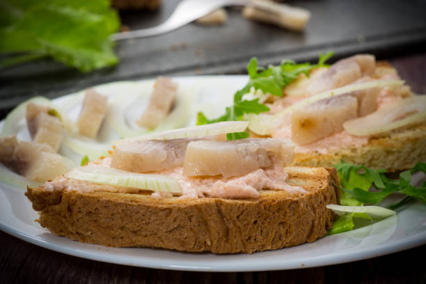 istock sandwich with salad, herring and herbs with onions in a plate 1226975965