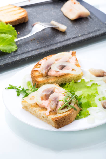 istock sandwich with salad, herring and herbs with onions in a plate 1226976208