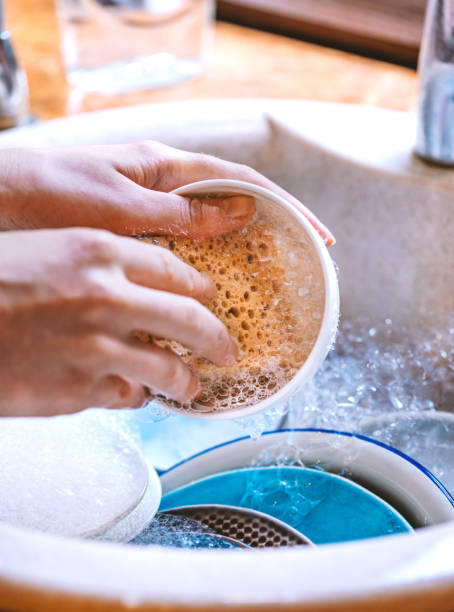 istock Woman washes dishes in the kitchen 1226977450