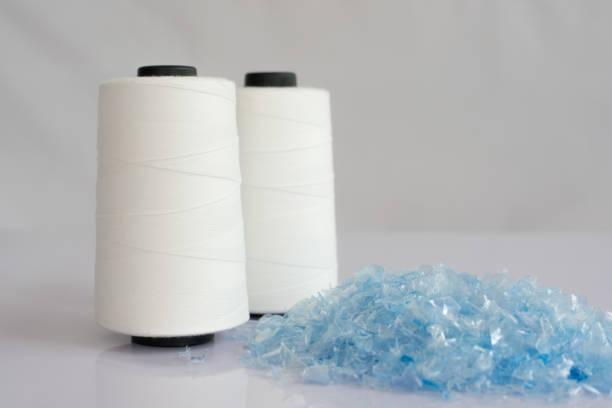 Bottle flake & Raw White Polyester FDY Yarn spool Bottle flake,PET bottle flake,Plastic bottle crushed,Small pieces of cut blue plastic bottles & Raw White Polyester FDY Yarn spool with white background polyester photos stock pictures, royalty-free photos & images