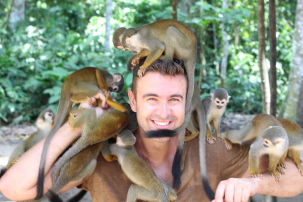 istock Man with a group of wild monkeys 1226979044