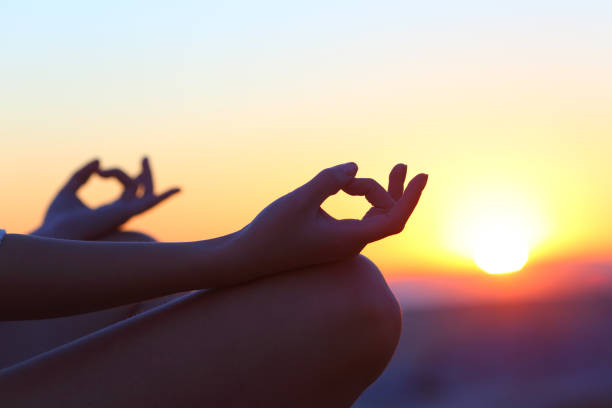 istock Woman hands at sunset relieving stress doing yoga 1226980652