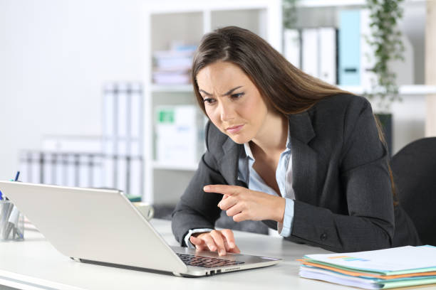 istock Suspicious executive reading on laptop at the office 1226981872