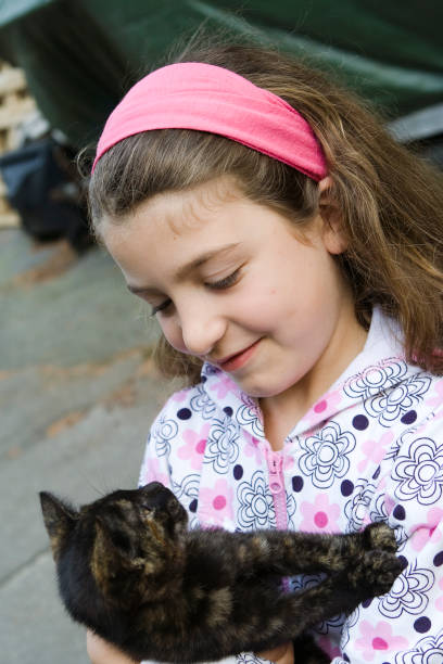 istock Girl embracing Black Cat 1226982338
