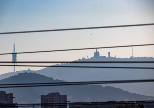 Barcelona, Spain. 20th May, 2020. Artsy view of the Collserola hill in Barcelona at sunset with Tibidabo church and Vallvidrera tower