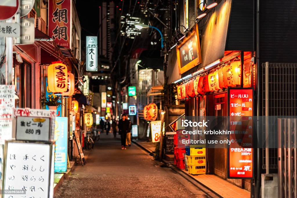 Shinjuku ward downtown street with izakaya restaurants at night and signs near Okubo station Tokyo, Japan - April 3, 2019: Shinjuku ward downtown with narrow alley lane street with izakaya restaurants at night and signs near Okubo station Izakaya Stock Photo