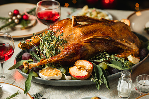 Close-up of delicious Christmas meal with roasted meat served on dinner table