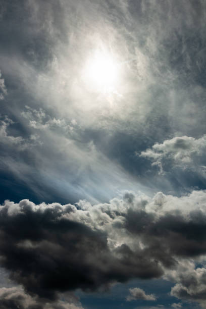 istock dramatic stormy sky with a blurred sun disk and heavy cumulus clouds against a dense cloud cover. artwork picture for fantasy, abstract or moody design or decoration 1226985383