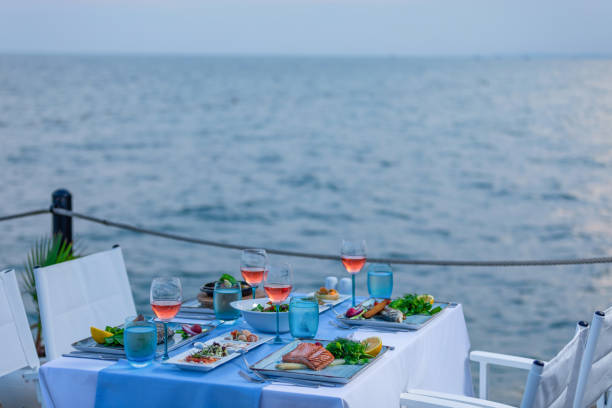 istock Various seafood dinner table ready at seaside with appetizers and drinks at afternoon 1226989451