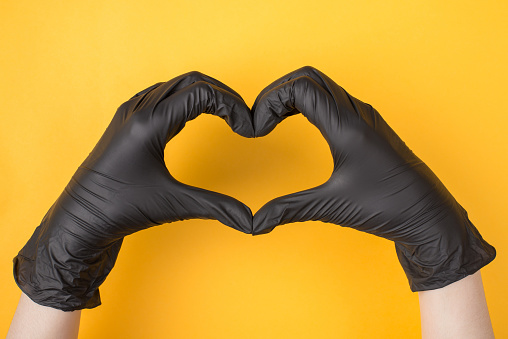 Closeup of blue rubber gloves on a white background.