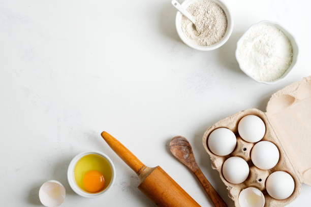 istock Baking ingredients for making homemade traditional bread or cakes on a light grey marble background. 1226991199