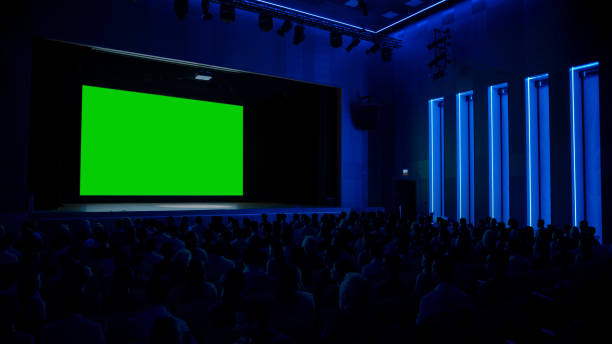 In Movie Theater Captivated Audience Watching New Blockbuster Film on Mock-up Green Screen. People Watching Video Game Tournament Streaming, Concert Video, Product Release Trailer. In Movie Theater Captivated Audience Watching New Blockbuster Film on Mock-up Green Screen. People Watching Video Game Tournament Streaming, Concert Video, Product Release Trailer. keynote speech stock pictures, royalty-free photos & images
