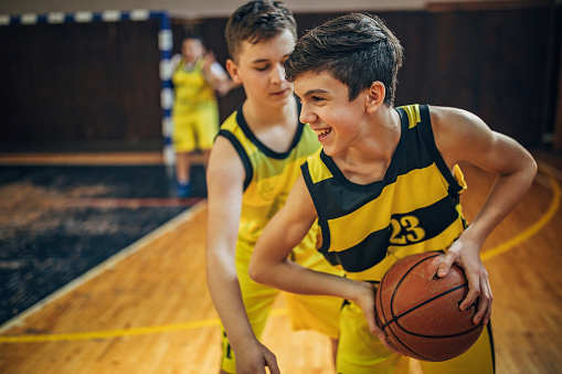 Group of men, teenage boys basketball players on training indoors..