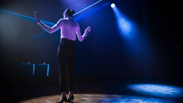 istock Famous Female Entertainer Stands on the Stage, Greets Audience, Starts Performance. Software Company Founder, Tech Marketing Guru Making a Pitch, Presentation Speaker Giving Talk. 1226991404