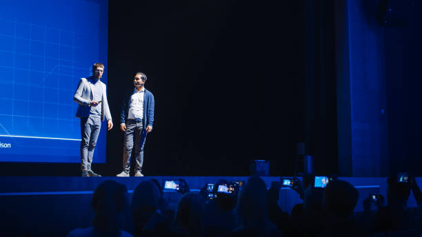 istock Startup CEO and Chief Developer Stand on Stage and Present New Product. Speakers Lead Lecture on Business, Science, Technology, Entrepreneurship, Health, Ecology, Leadership and all Things Digital 1226991413