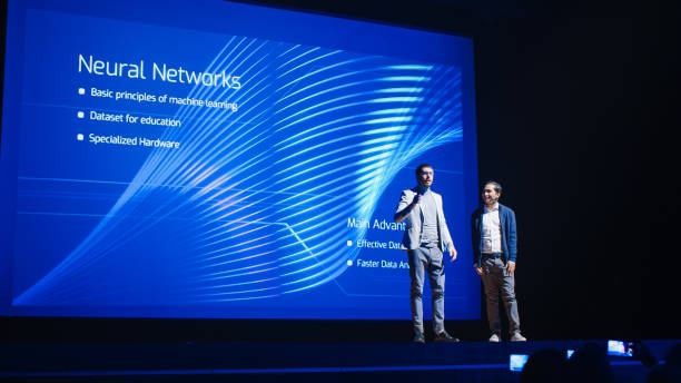 istock Startup CEO and Chief Developer Stand on Stage and Present New Product. Speakers Lead Lecture on Business, Science, Technology, Entrepreneurship, Health, Ecology, Leadership and all Things Digital 1226991438