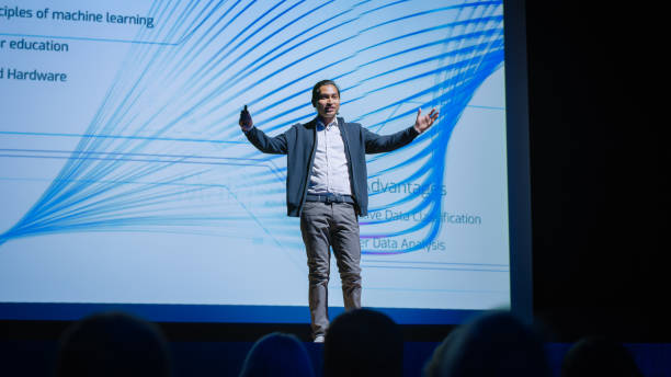 istock Startup Conference Stage: Speaker Presents New Product, Talks about Performance, Neural Networks, Artificial Intelligence, Big Data and Machine Learning. Live Event, Device Release, Start-up Business 1226991536