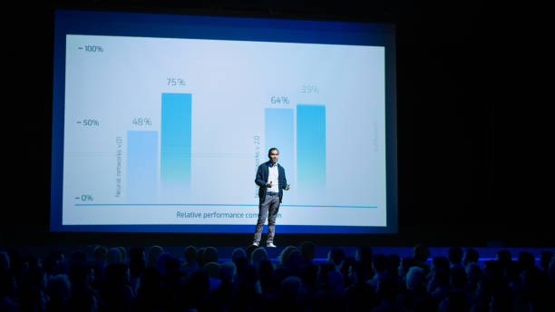 istock Startup Conference Stage: Speaker Presents New Product, Talks about Performance, Neural Networks, Artificial Intelligence, Big Data and Machine Learning. Live Event with Large Audience 1226991599