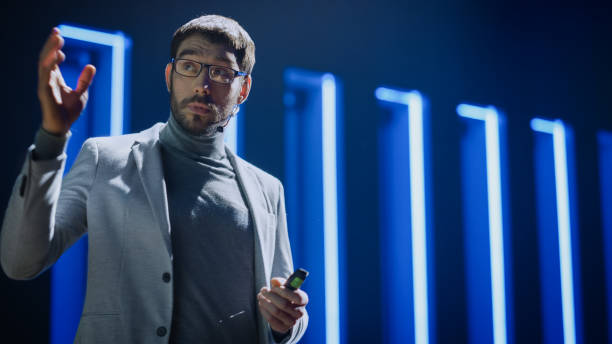 istock Business Conference Stage: Hardware Developer Startup CEO Presents New Product, Does Motivational Talk. Speaker does Lecture about Science, Technology, Entrepreneurship, Development, Leadership 1226991759