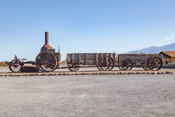 ボレート採掘のための死の谷の鉱山道路を提供する古い蒸気トラクターとワゴン - furnance creek ranch ストックフォトと画像