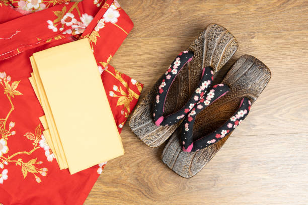 Japanese traditional geta sandal and traditional clothes of Kimono, Yukata on wooden floor. Japanese traditional geta sandal and traditional clothes of Kimono, Yukata on wooden floor. geta sandal photos stock pictures, royalty-free photos & images