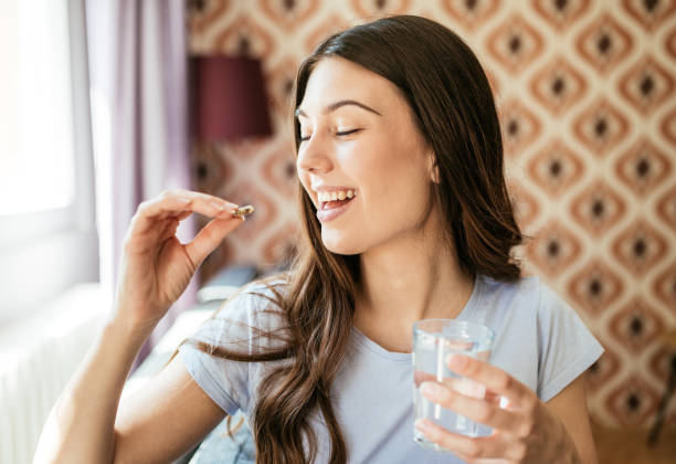 istock Healthy young woman taking herbal supplements 1226994186