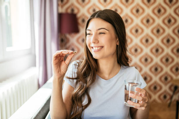 istock Healthy young woman taking herbal supplements 1226994285