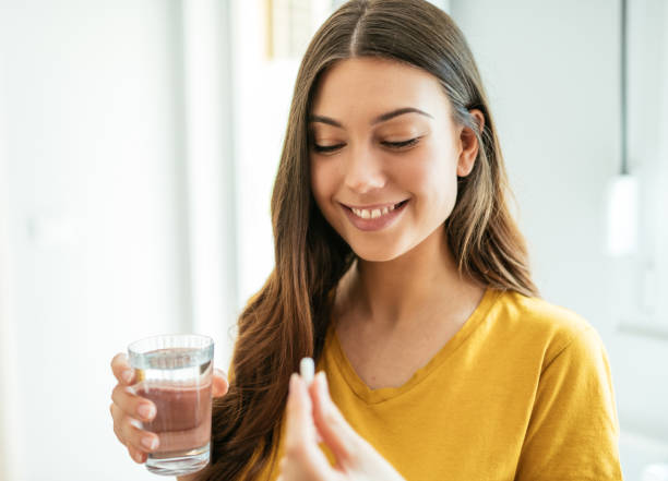 istock Healthy young woman taking herbal supplements 1226994318