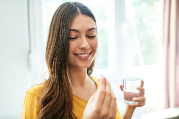 istock Healthy young woman taking herbal supplements 1226994374