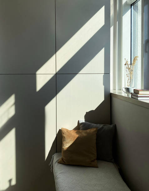 istock Bench with cushions by the window in modern apartment 1226994713