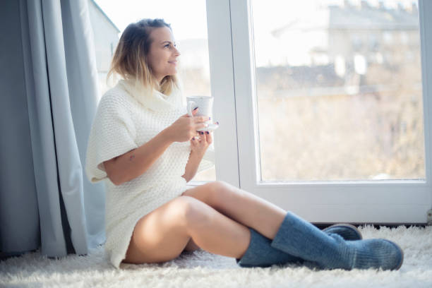 Picture showing young woman stretching at home in the morning