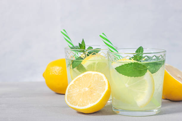 istock Lemon lemonade with herb on grey background. 1226995635