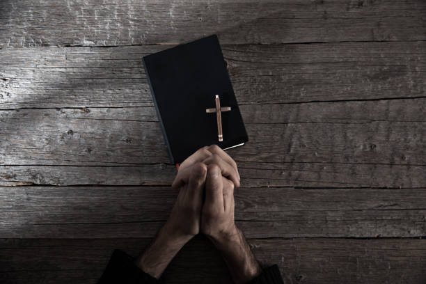istock Man hand cross with Bible 1226996030