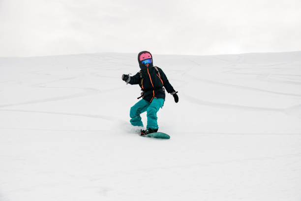 istock Freerider snowboarder moving down in snow powder 1226997942