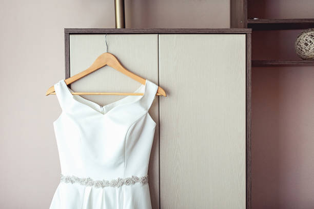 istock Simple white wedding dress on the rack at the wardrobe 1227001973