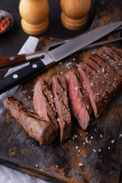 istock Cooked and sliced beef steak on cutting board 1227003514