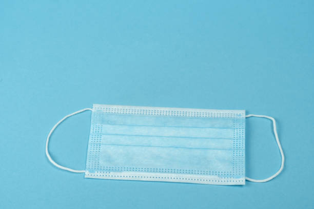 istock Surgical mask with rubber ear straps. Procedure mask from bacteria. 1227004294