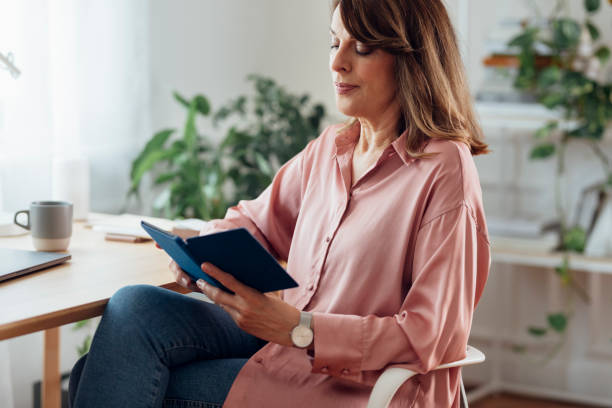 istock Senior Woman Reading an E-Book from Home 1227007602