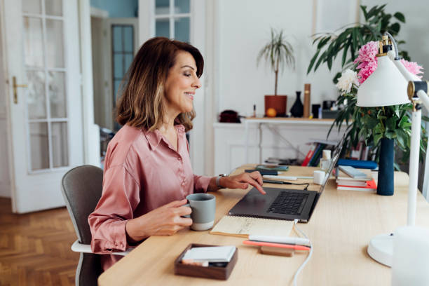 istock Happy Senior Woman Sitting in her Home Office and Using her Laptop Computer 1227007639