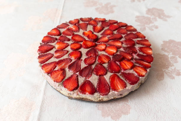 Homemade strawberry cheesecake served on the table ready to be sliced