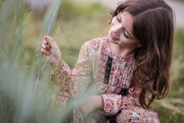 istock Adorable girl observing wheat field and smiling 1227008870