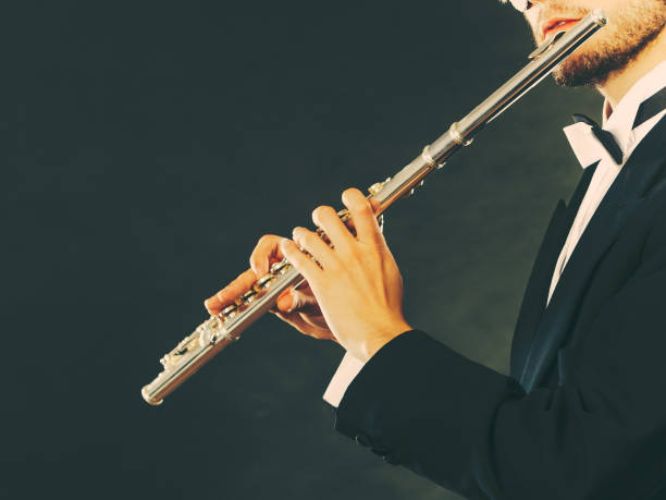 istock Elegantly dressed male musician playing flute 1227010203
