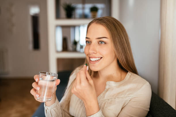 istock Healthy young blond hair woman taking supplements 1227011249
