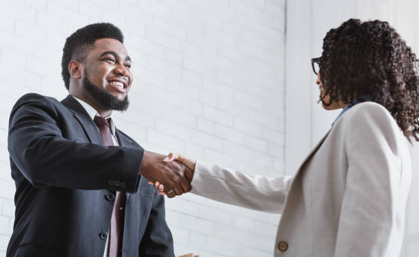 istock African American business partners shaking hands in office, making agreement 1227011419